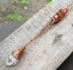 A side view of a Woven Dread Bead with a Arkansas Quartz.