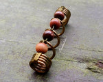 A top view of a Earthy Dreadlock bead. 