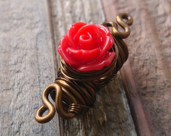 A close up view of a Red Rose Dread Bead.