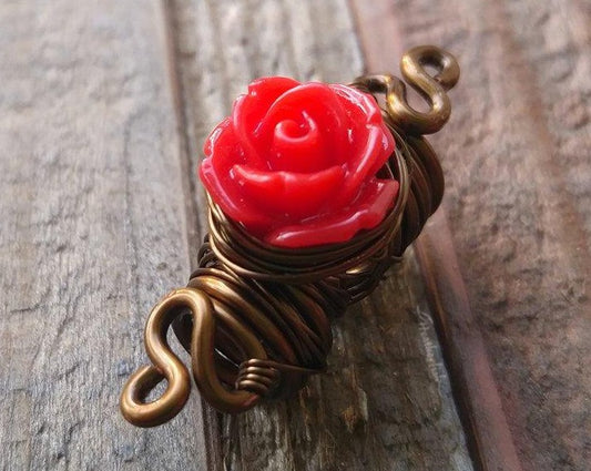 A close up view of a Red Rose Dread Bead.