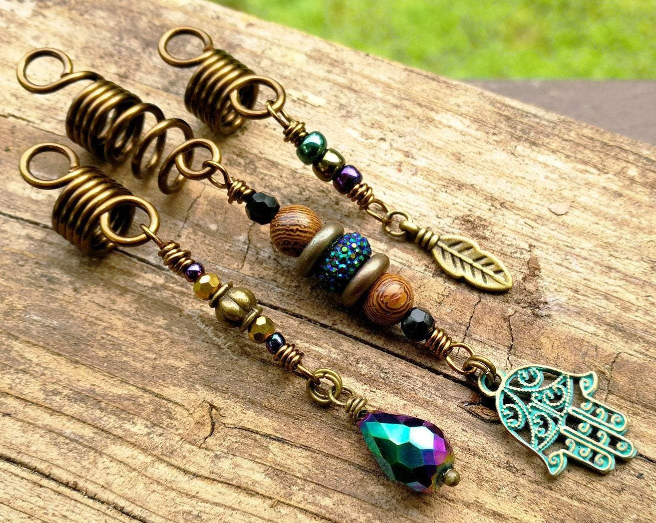 A top view of Hamsa Loc jewelry Set of 3 on a wooden background.