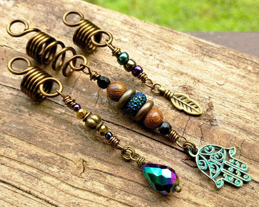 A top view of Hamsa Loc jewelry Set of 3 on a wooden background.