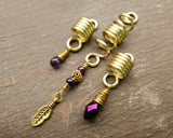 A front view of Gold Amethyst Dread Beads Set of 3.