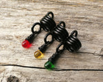 A top view of Rasta Dread Beads Set of 3 Glass Drops.
