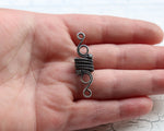 A top view of a Elegant Silver Dread Bead in hand.