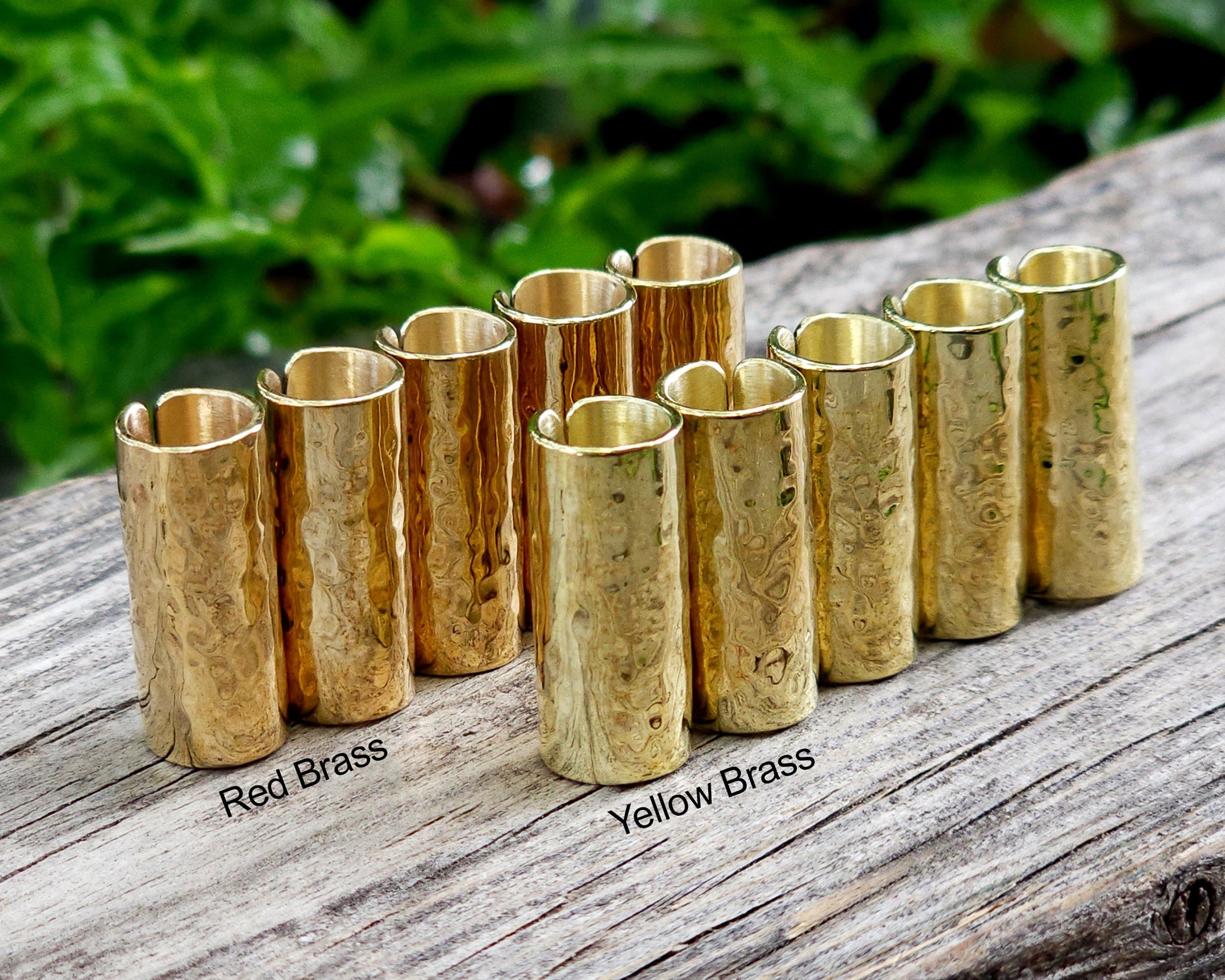 Brass hair cuffs on a wood surface.