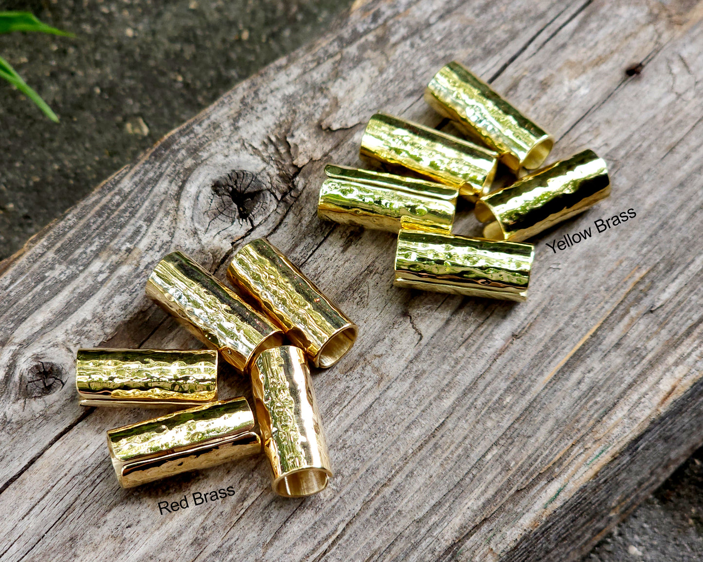 Brass hair cuffs on a wood surface.