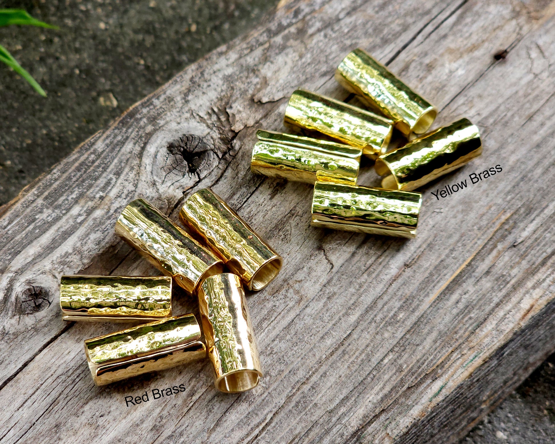 Brass hair cuffs on a wood surface.