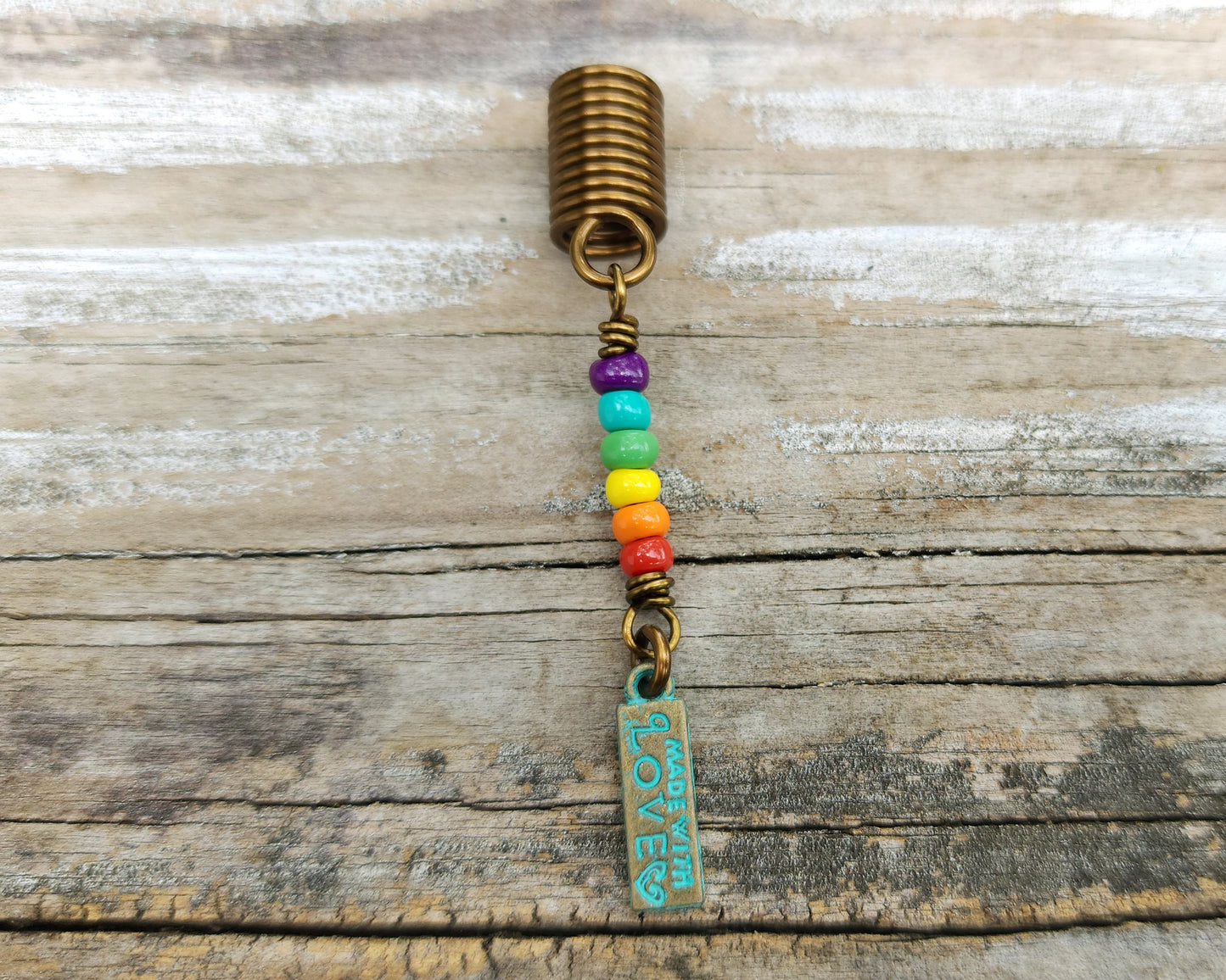 Made with Love Pride Loc Jewelry on a wood background.