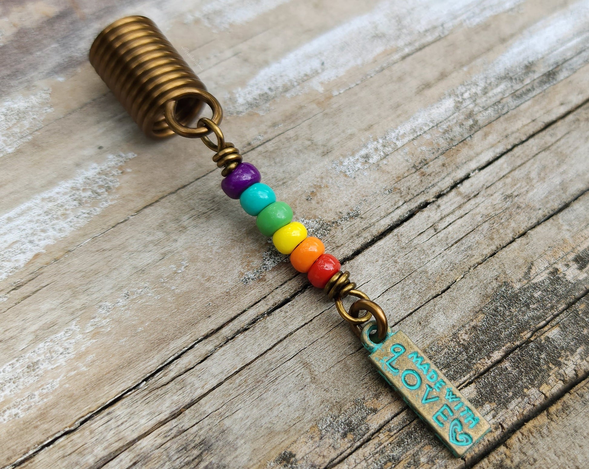 Made with Love Pride Loc Jewelry on a wood background.