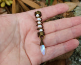 Pearl Moonstone Loc Bead held in hand to show scale.