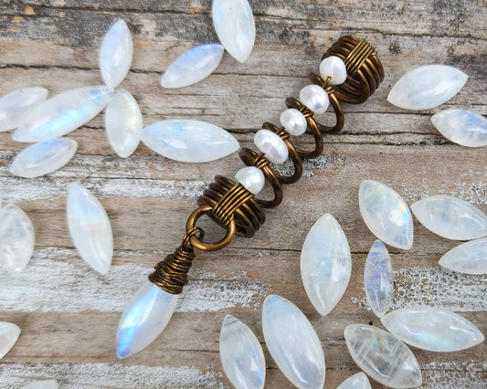 Pearl Moonstone Loc Bead on a wood background.