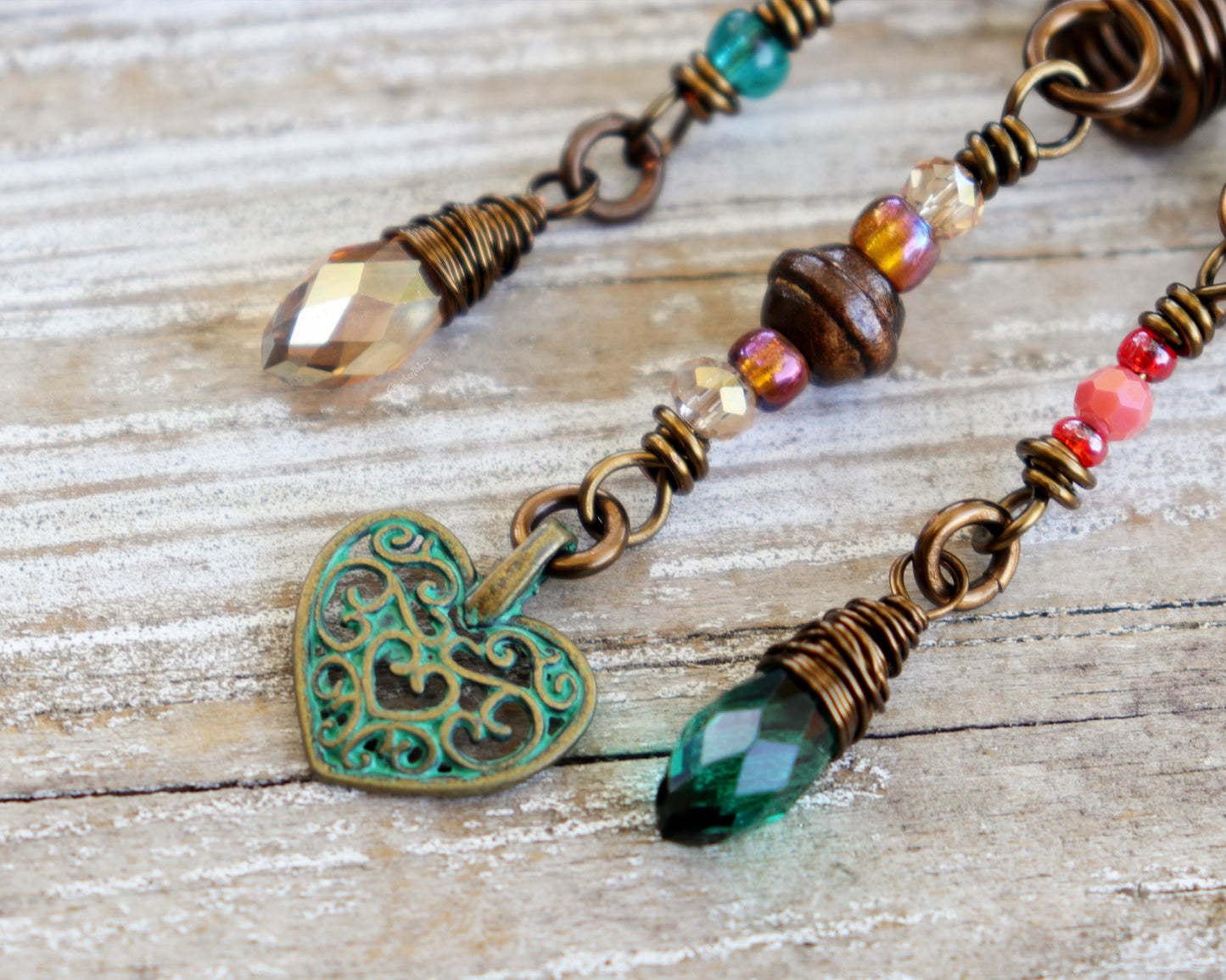 Set of 3 dreadlock beads on a wood background.