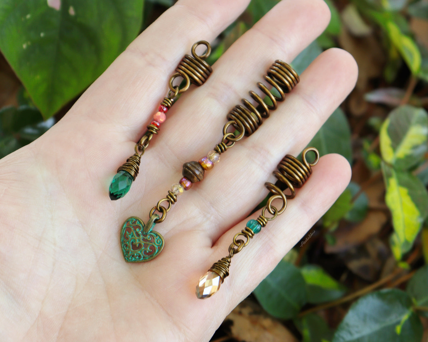 Set of 3 dreadlock beads held in hand to show scale.