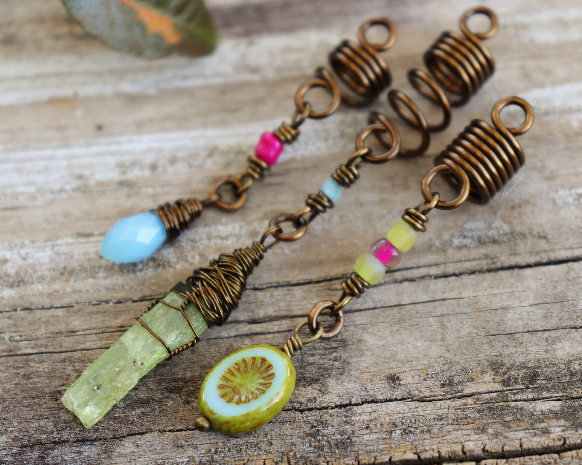 Spring themed set of three hair beads on a wood background.