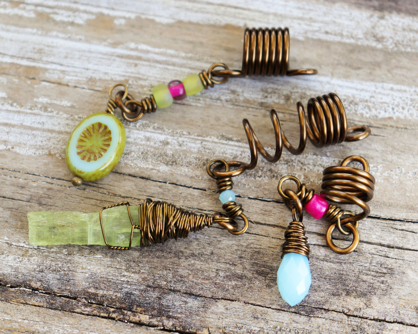 Spring themed set of three hair beads on a wood background.