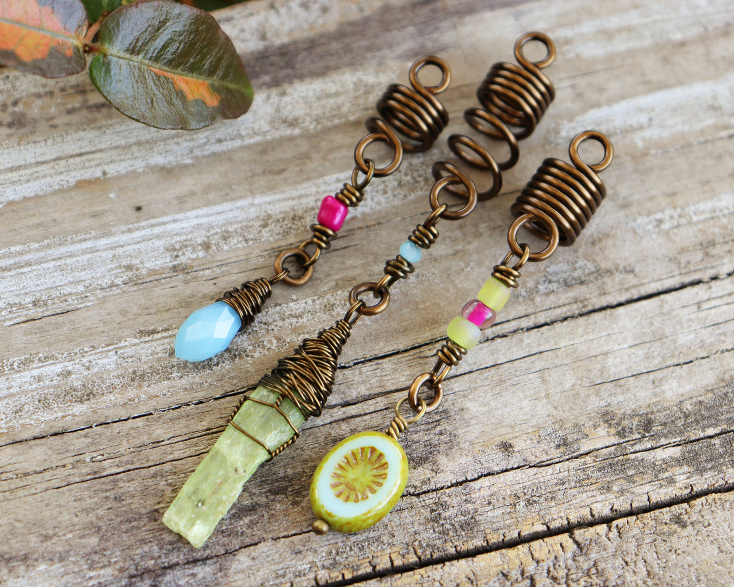 Spring themed set of three hair beads on a wood background.