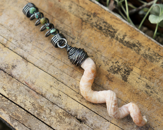 Hair jewelry featuring a silver coil accented with Hubei Turquoise beads and the spiral sea shell from a Florida tube snail.