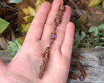 Orange Kyanite Hair Bead, Hessonite Garnet held in hand to show scale.