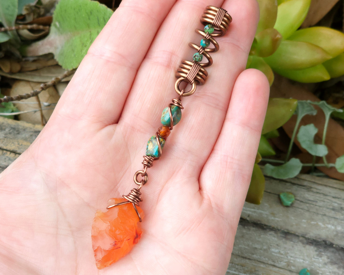 Carnelian Arrowhead Hair Bead held in hand to show scale.