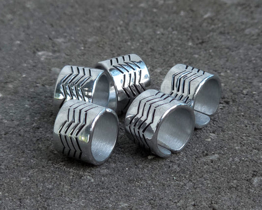 Aluminum hair cuffs with a zigzag stamped pattern on a stone background.