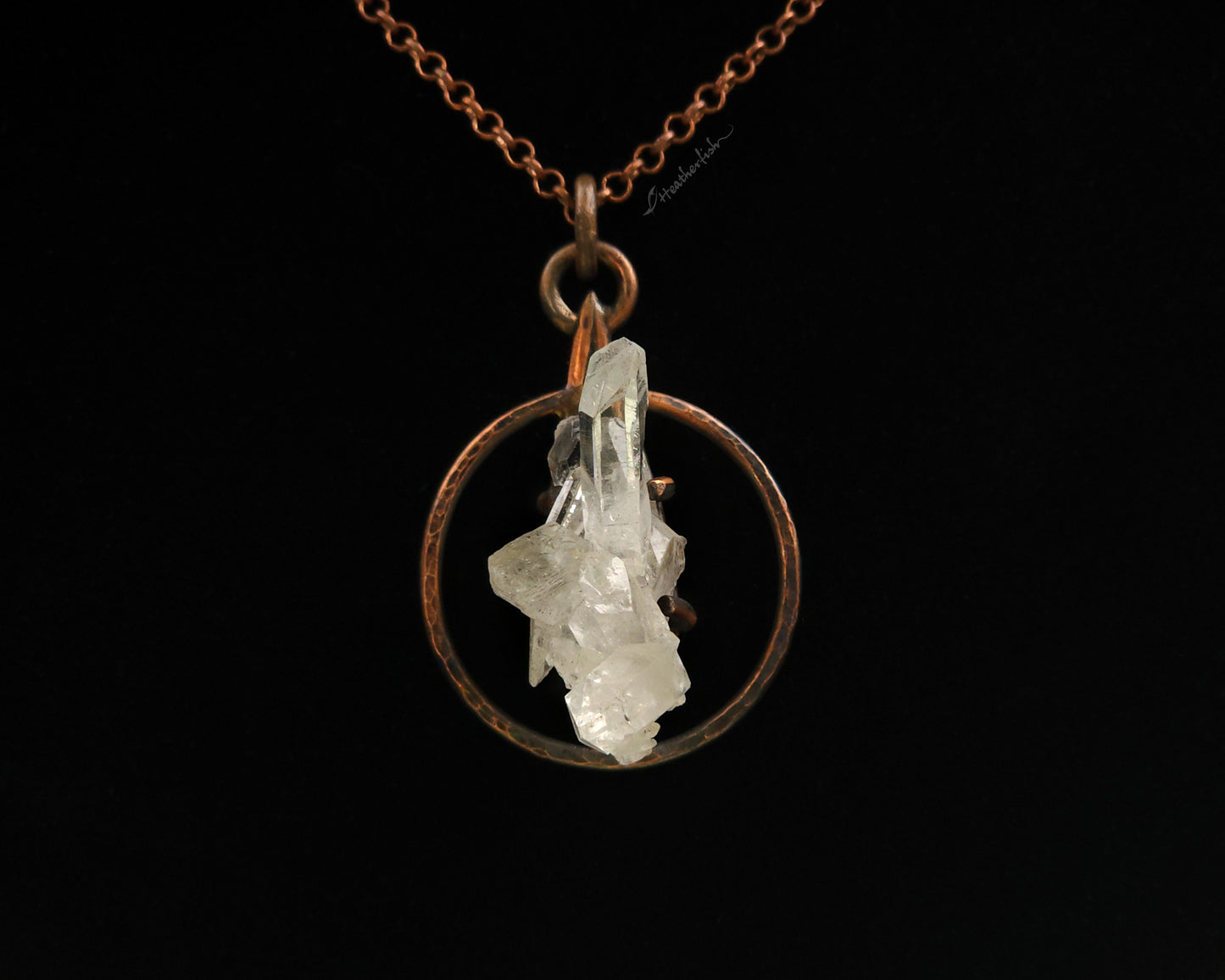 Crystal pendant necklace on a black background