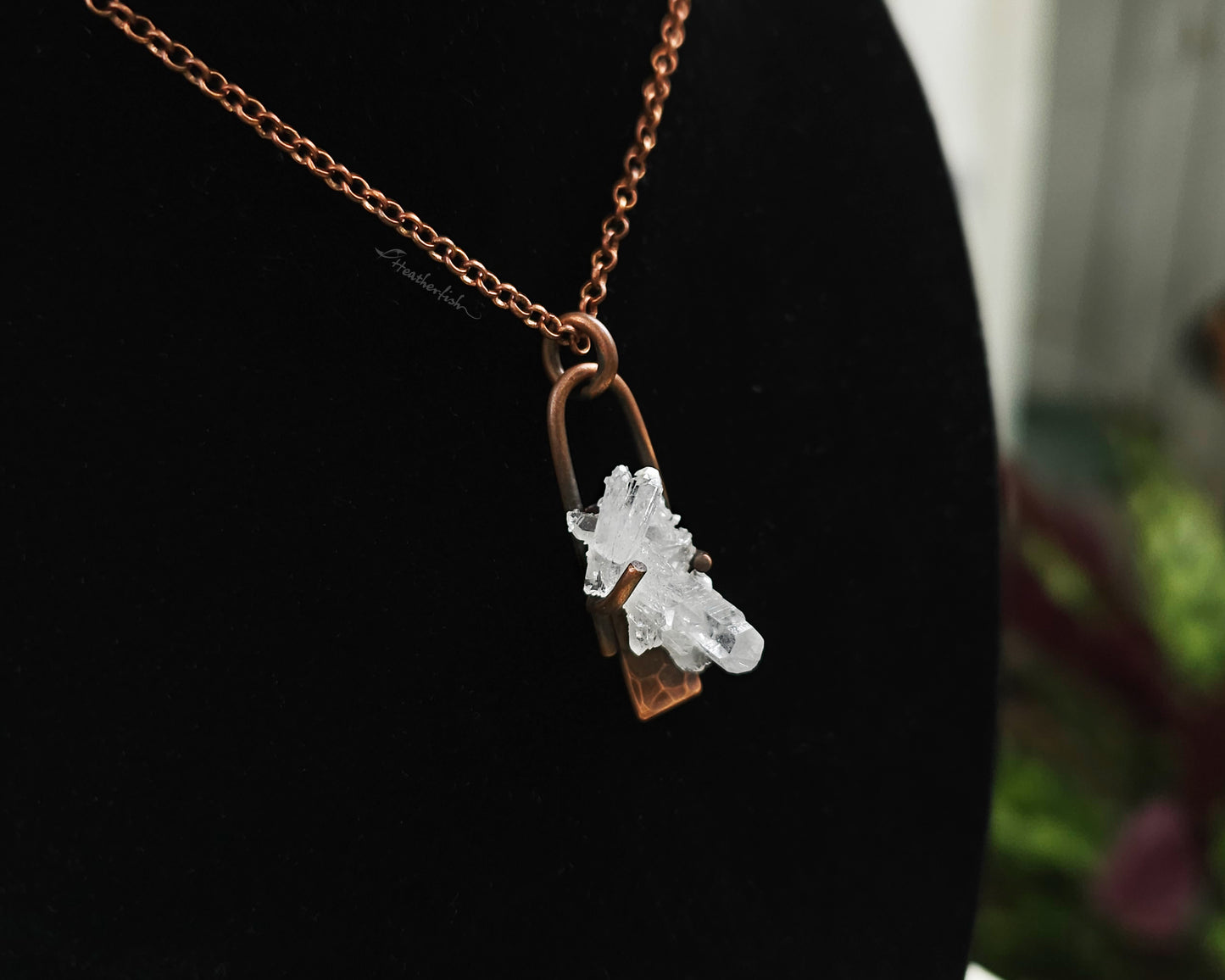 Quartz Cluster Necklace with copper chain against a black background.
