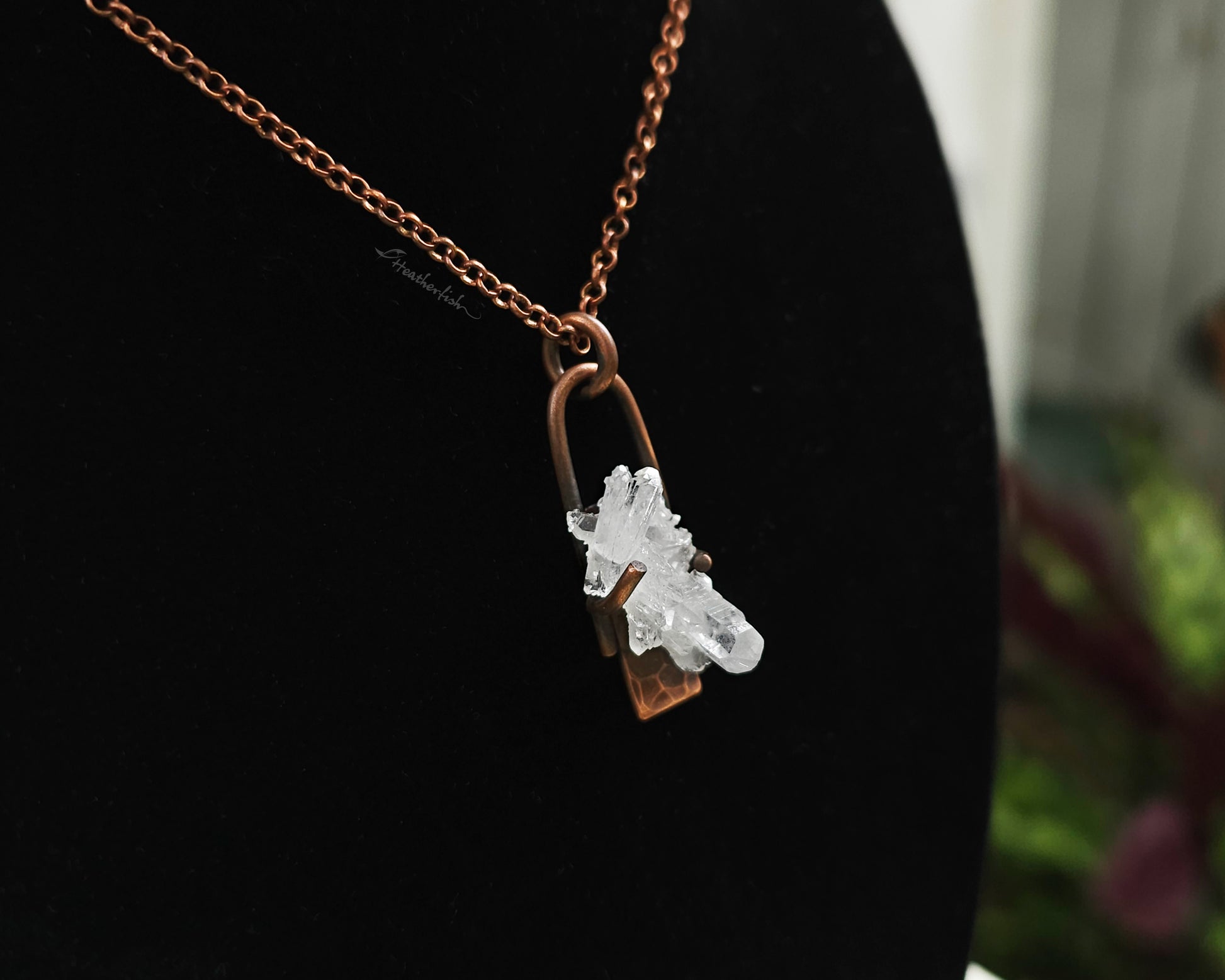 Quartz Cluster Necklace with copper chain against a black background.