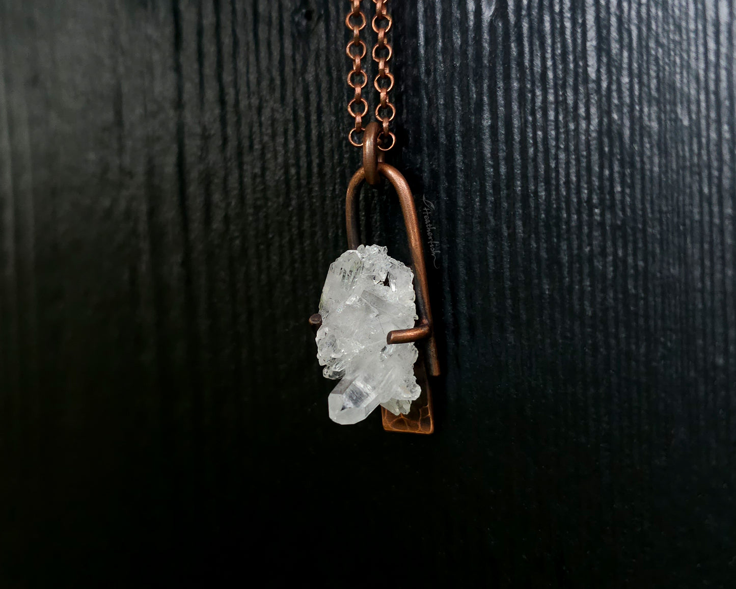 Quartz Cluster Necklace with copper chain against a black background.