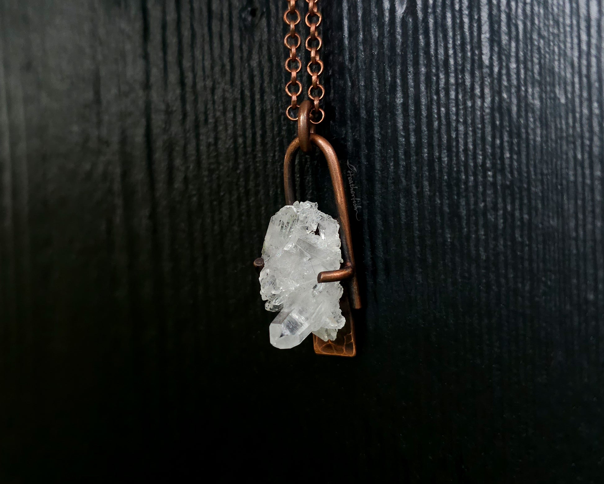 Quartz Cluster Necklace with copper chain against a black background.