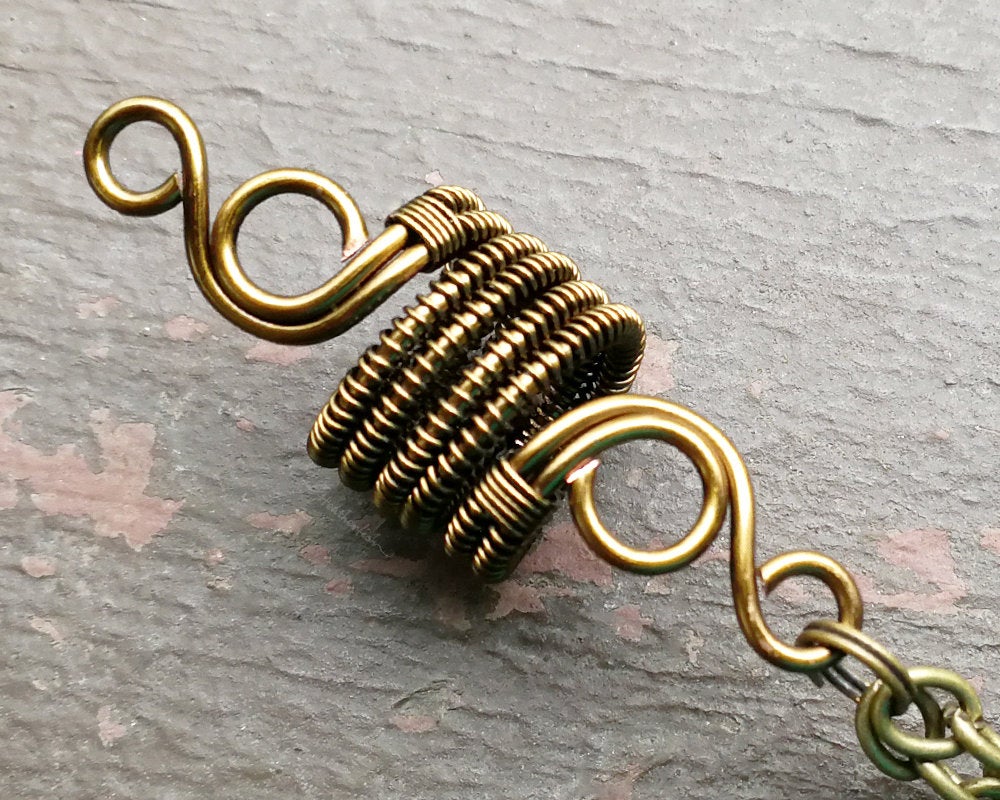 A close up of Double Crystal Woven Dread Bead in detail. 