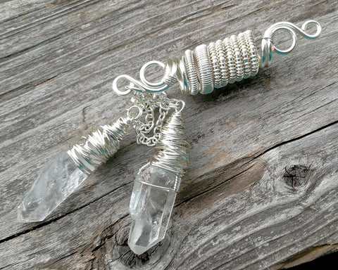 Top view of double quartz dread bead on weathered wood surface.