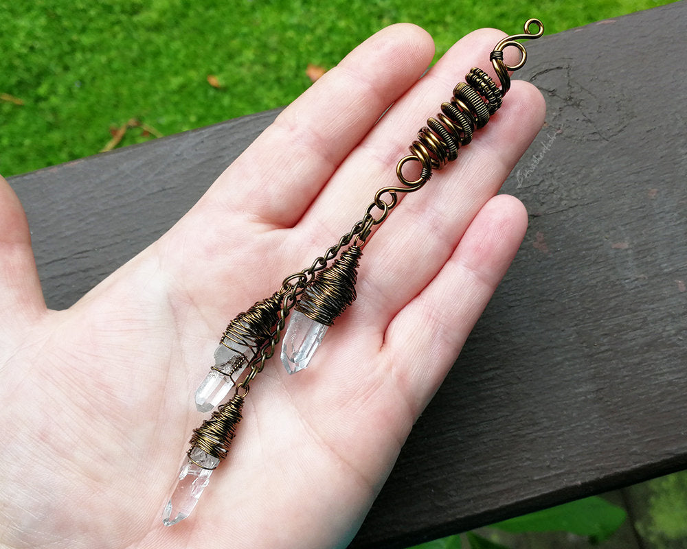 A top view of a Triple Crystal Dread Bead in hand.