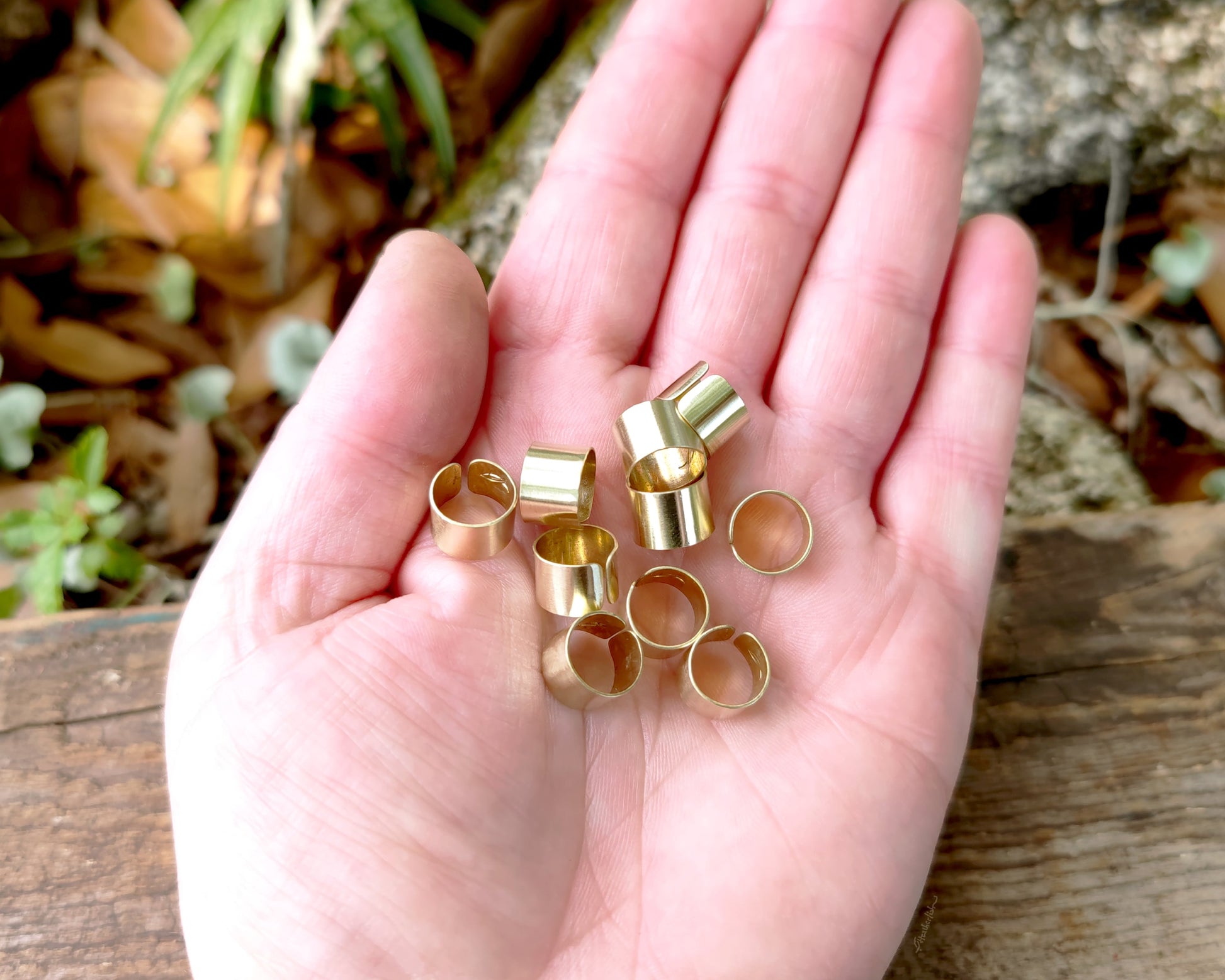 Brass Cuffs held in hand to show scale.