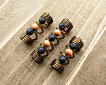 A top view of Diffuser Dread Bead Set of 3 on a wooden background.