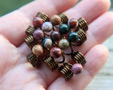 Set of 5 jasper dread beads in hand to show scale.