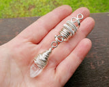Woven Silver Dread Bead featuring and arkansas quartz crystal in a hand to show size.