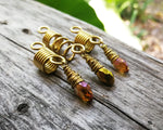 Amber and gold dread bead set of 3 displayed on wood background