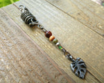 A top view of a Hematite Leaf Dread Bead.