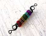 A close up view of a Rainbow Pride Dread Bead.