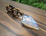 A side view of a Opalite Glass Arrowhead Dread Bead.