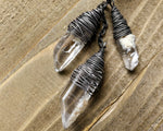 Silver Crystal Dread Bead, Ivory Inclusions on wood background.