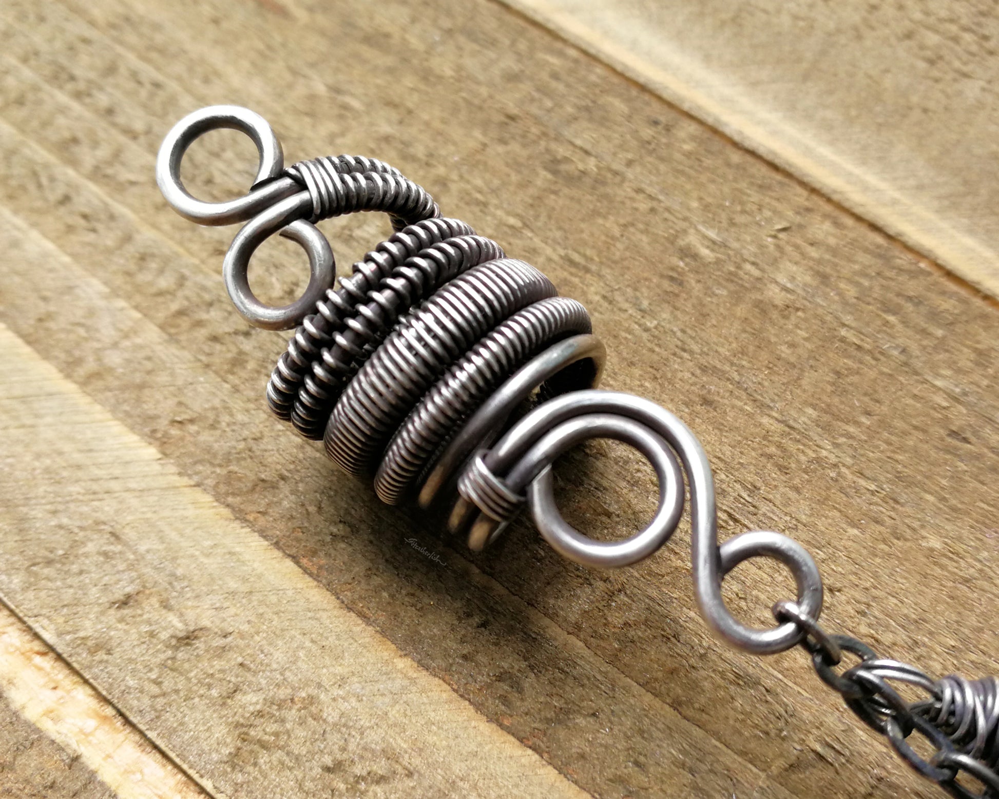 Silver Crystal Dread Bead, Ivory Inclusions on wood background. Close up of woven coil.