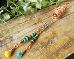 Yellow Jasper, Turquoise Dread Bead on a wood background.