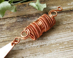 Close up of the woven coil on a long bohemian copper loc bead.
