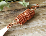 Close up of the woven coil on a long bohemian copper loc bead.
