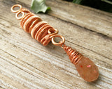 Sunstone Copper Dread Bead on wood background.