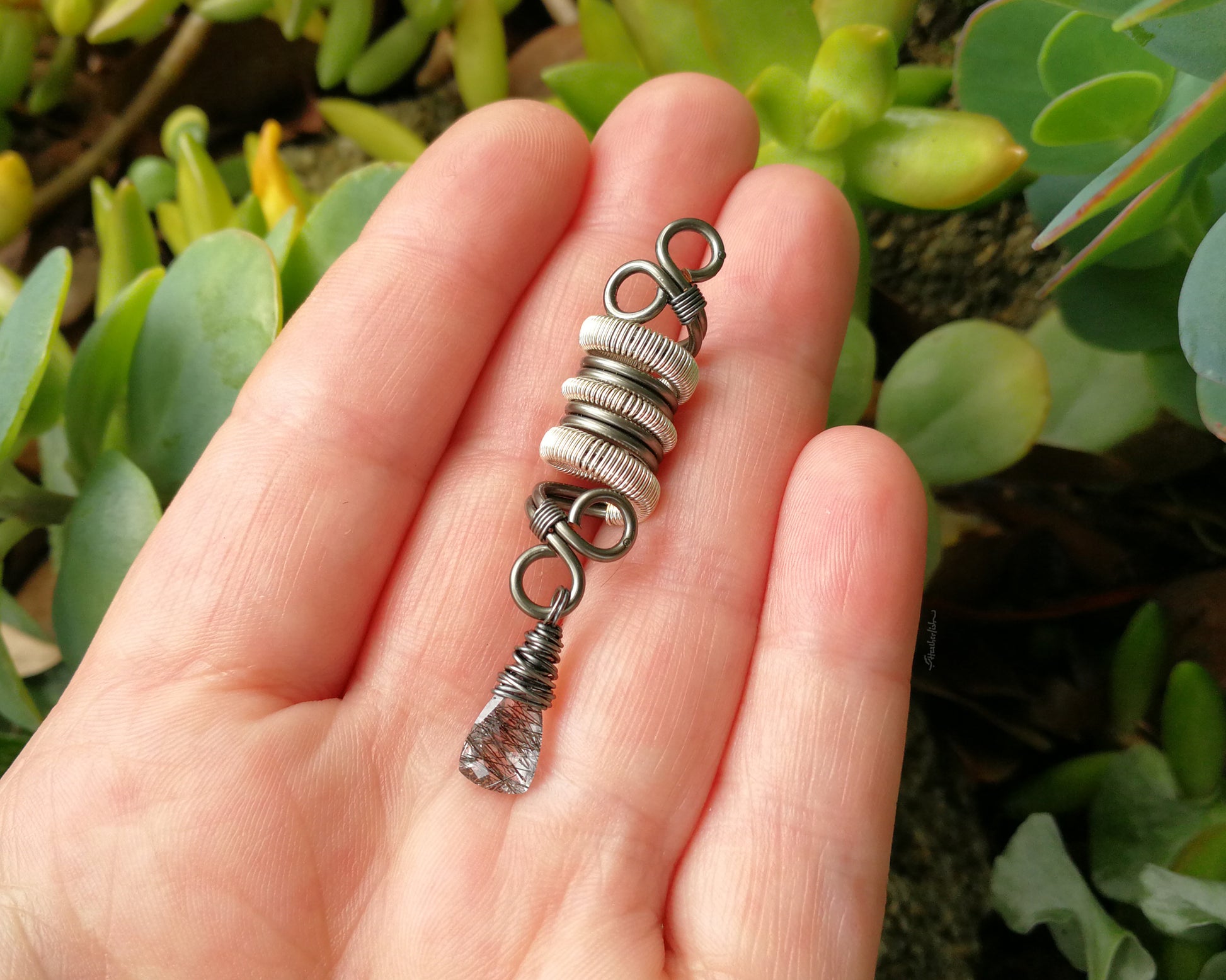 Two Tone Rutilated Quartz Dread Bead in hand to show scale.