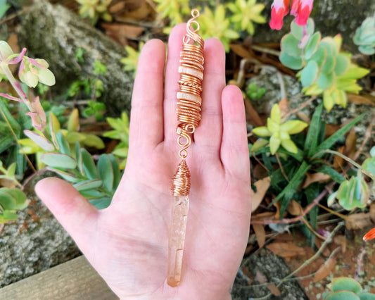 Iron quartz dread bead held in hand to show scale.