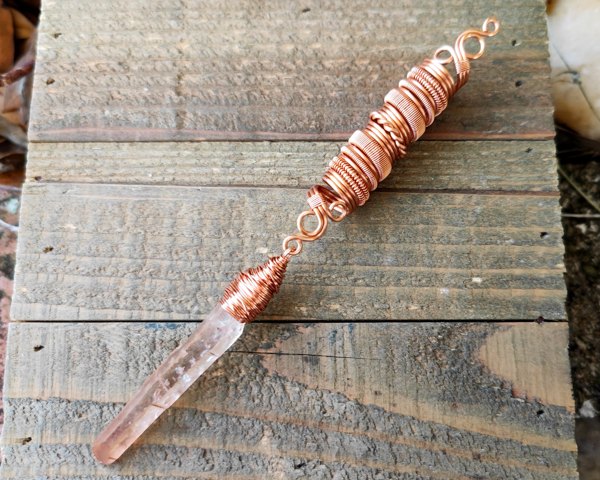 Iron quartz dread bead on wood background.